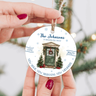Personalized New Home Christmas Ornament featuring a festive front door with a wreath and two decorated trees, customized with family name, house address, and year, making a unique new home or housewarming keepsake.