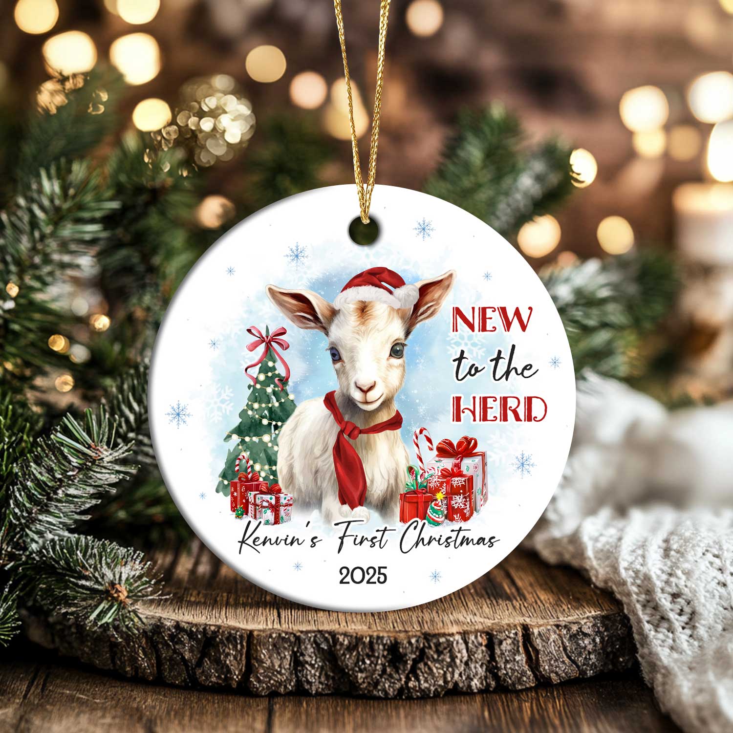 Personalized Baby's First Christmas Ornament featuring a cute baby goat wearing a Santa hat and red scarf, with Christmas tree, presents, and text New to the Herd, customized with baby’s name and year.