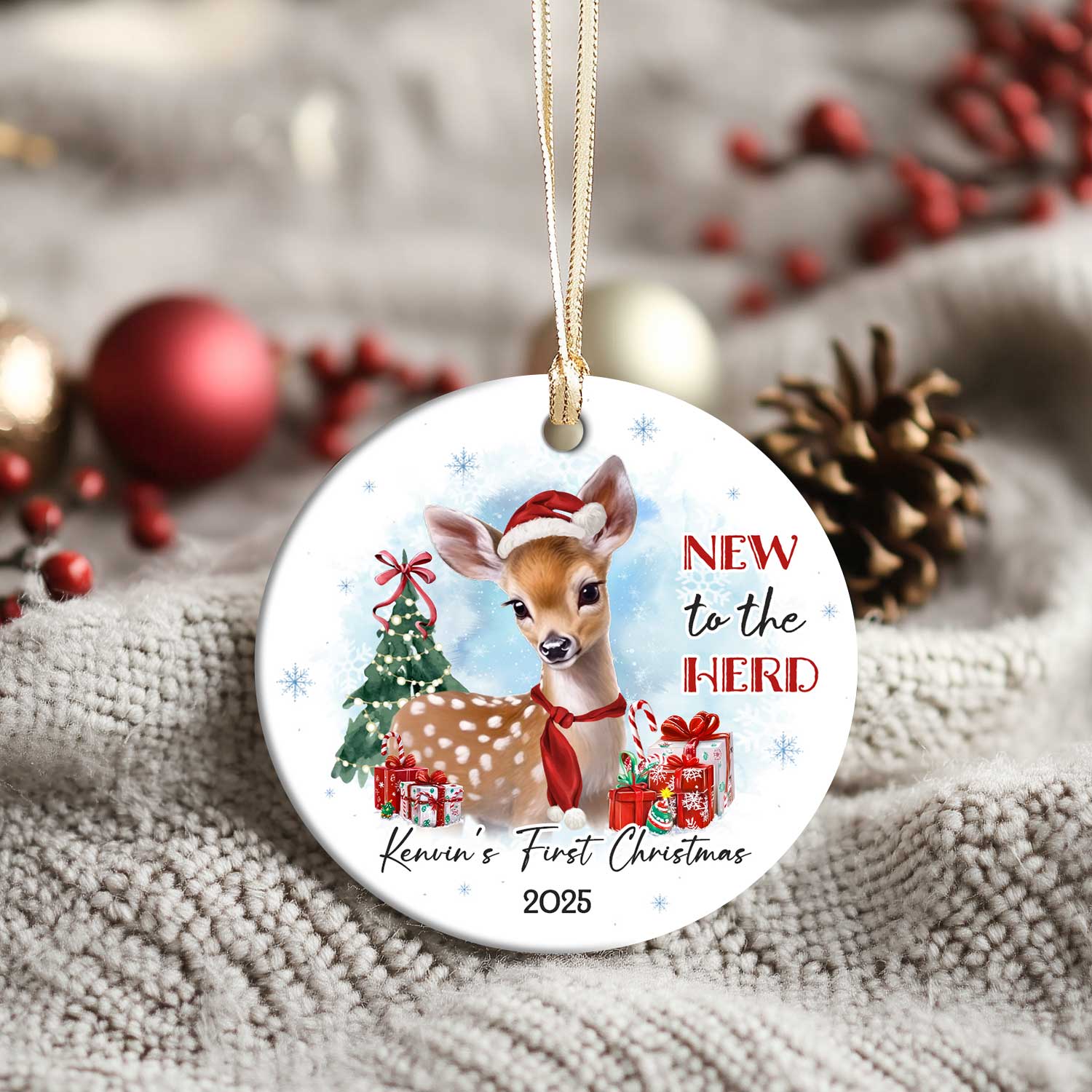 Baby's First Christmas Ornament featuring a cute baby deer wearing a Santa hat and red scarf, with Christmas tree, presents, and the text New to the Herd, customized with baby’s name and year.