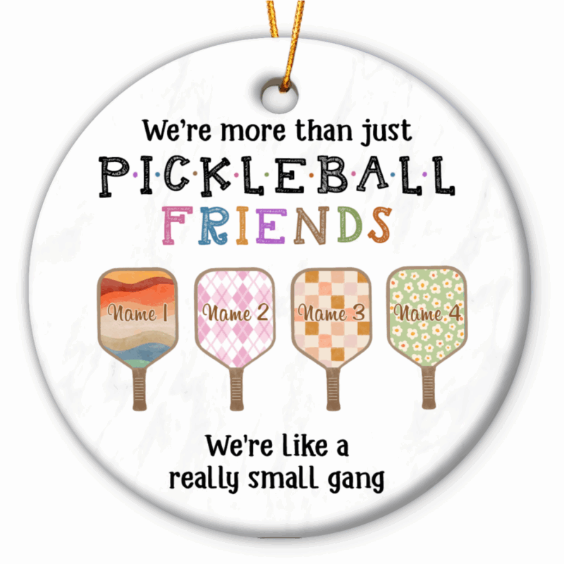 Personalized Pickleball Ornament - Sport Gift for Pickleball Lover featuring colorful paddles with custom names and the quote ‘We’re more than just pickleball friends, we’re like a really small gang,’ hanging on a Christmas tree, the perfect gift for pickleball lovers and friends.