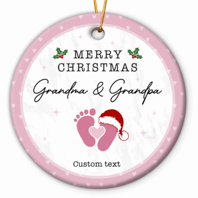 Personalized Baby Announcement Ornament - Christmas Gift for Grandparents featuring baby footprints with a Santa hat and customizable text for names and year, held by hand near a Christmas tree - perfect Christmas pregnancy reveal or gift for grandparents-to-be