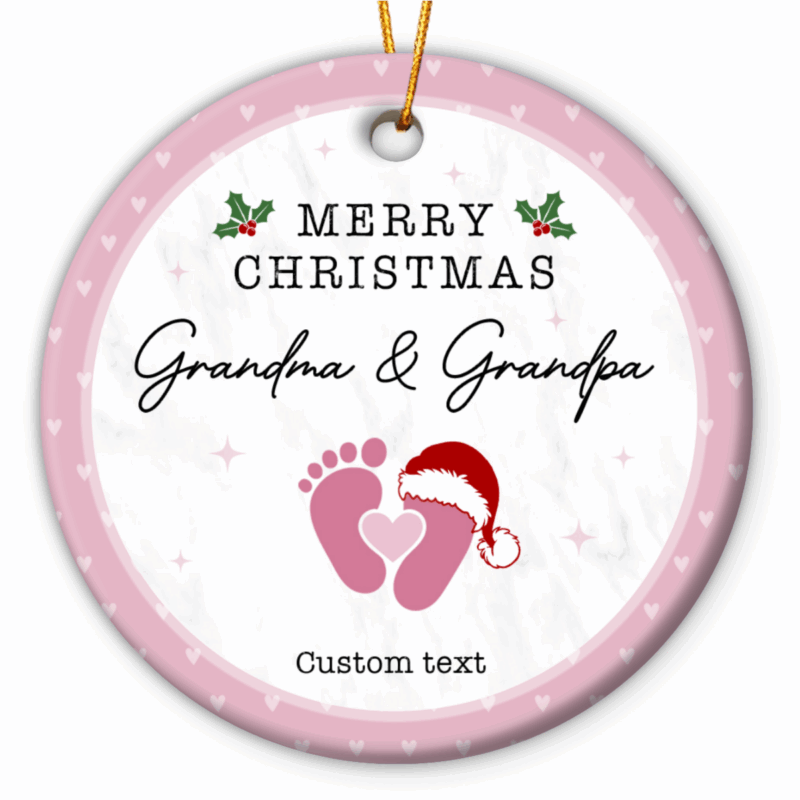 Personalized Baby Announcement Ornament - Christmas Gift for Grandparents featuring baby footprints with a Santa hat and customizable text for names and year, held by hand near a Christmas tree - perfect Christmas pregnancy reveal or gift for grandparents-to-be