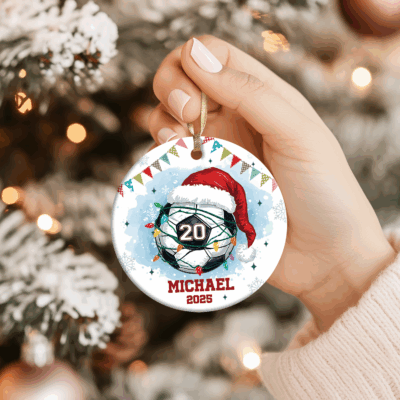 Personalized Soccer Christmas Ornament - Gift For Soccer Lovers featuring a soccer ball with Santa hat and Christmas lights, custom name and number, holiday gift for soccer players or sports lovers, keepsake hanging on Christmas tree.