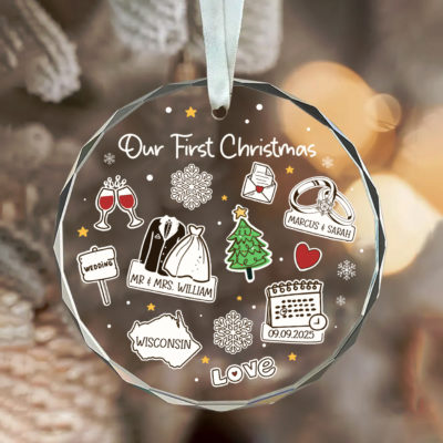 Our First Christmas Glass Ornament – Personalized Newlywed Gift featuring couple’s names, wedding icons, and date, with festive decorations and “Our First Christmas” text, hanging on Christmas tree as a newlywed keepsake gift.