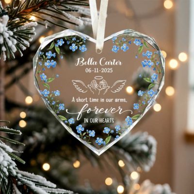 Custom Baby Loss Heart Glass Ornament - Baby Memorial Gift with blue forget-me-not flowers, personalized with name, date, and angel wings design, featuring the quote “A short time in our arms, forever in our hearts,” hanging on a Christmas tree.