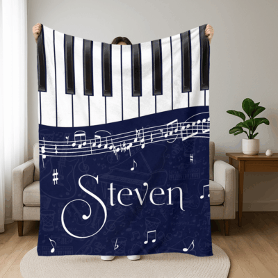 Personalized piano blanket with custom name and black-and-white piano design
