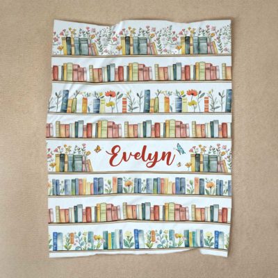 Personalized book lover blanket with custom name and floral bookshelf design – cozy fleece reading gift for girls and women.
