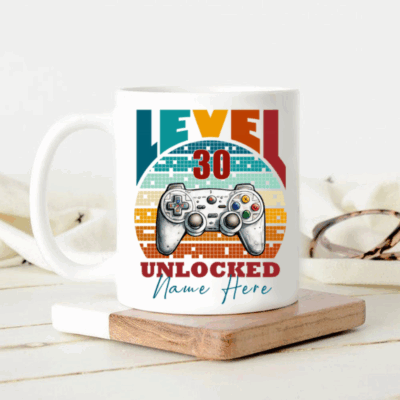 Personalized gamer birthday mug with custom name and age level unlocked design featuring video game controller graphic