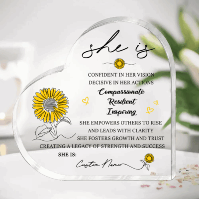 Personalized She Is Heart Acrylic Plaque featuring a custom name, sunflower illustrations, and inspirational affirmations celebrating confidence, resilience, compassion, and leadership, designed as an appreciation gift for women and coworkers.