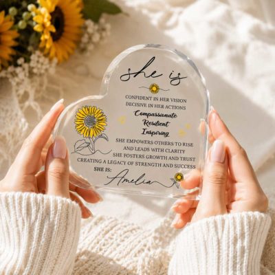 Personalized She Is Heart Acrylic Plaque featuring a custom name, sunflower illustrations, and inspirational affirmations celebrating confidence, resilience, compassion, and leadership, designed as an appreciation gift for women and coworkers.